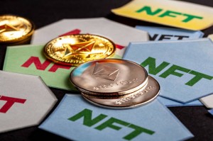 Clarksburg, MD, USA 05-01-2021: A concept image for investing in Non Fungible Tokens (NFTs) through Ethereum blockchain. These are rare digital items that are traded online. Image shows NFTs with ETH coins on dark background