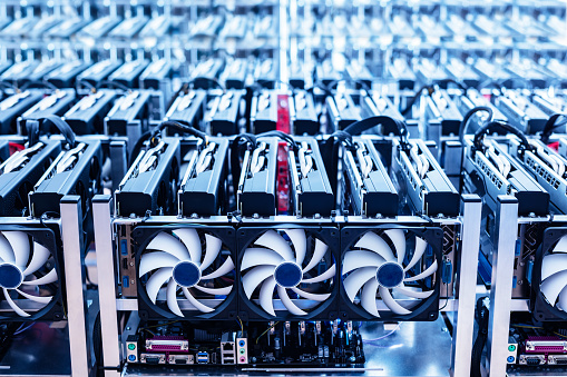 Bitcoin mining farm. IT hardware. Electronic devices with fans. Cryptocurrency miners.