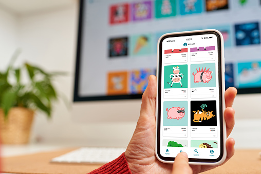 NFT marketplace app on mobile phone with hands close up investment in crypto art non fungible tokens