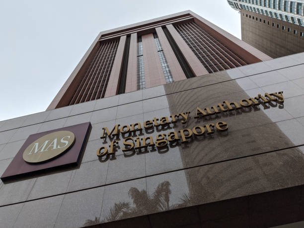 Singapore. May 2020. This picture was taken during the COVID-19 and depicts the MAS logo and sign with lettering at the entrance to the MAS (Monetary Authority of Singapore) building. The brown and tall building stands as the background depicting the greatness of the financial system. The Monetary Authority of Singapore is Singapore's central bank and financial regulatory authority.