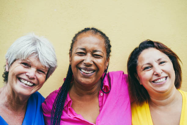 Portrait of multiracial senior women having fun outdoor - Focus on african woman face